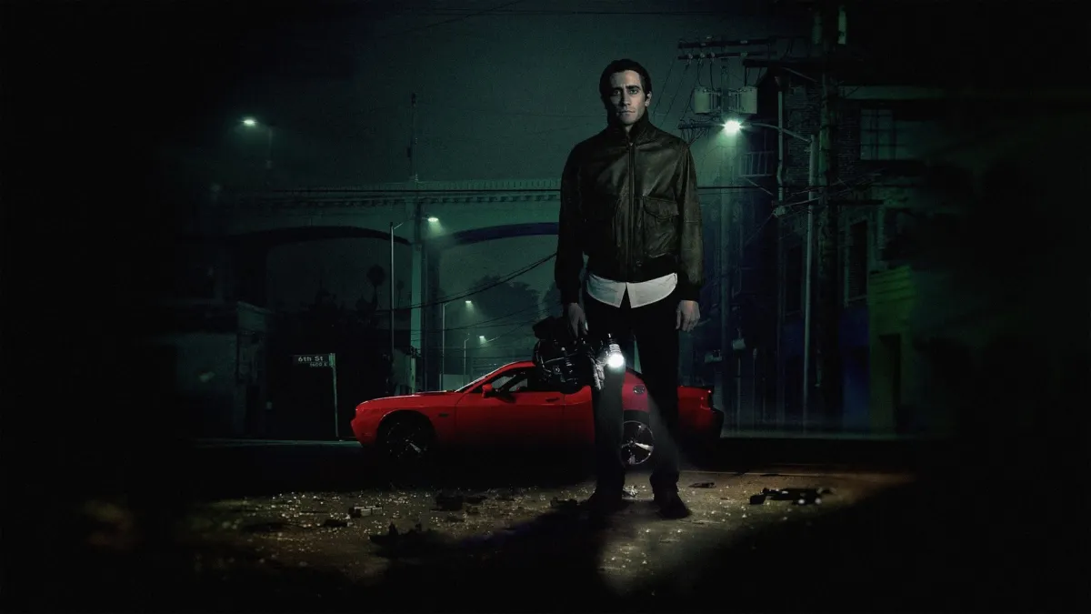 Jake Gyllenhaal as Lou Bloom behind the wheel of a Dodge Challenger in Nightcrawler
